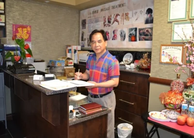 Staff member at reception desk in Scarborough massage therapy clinic